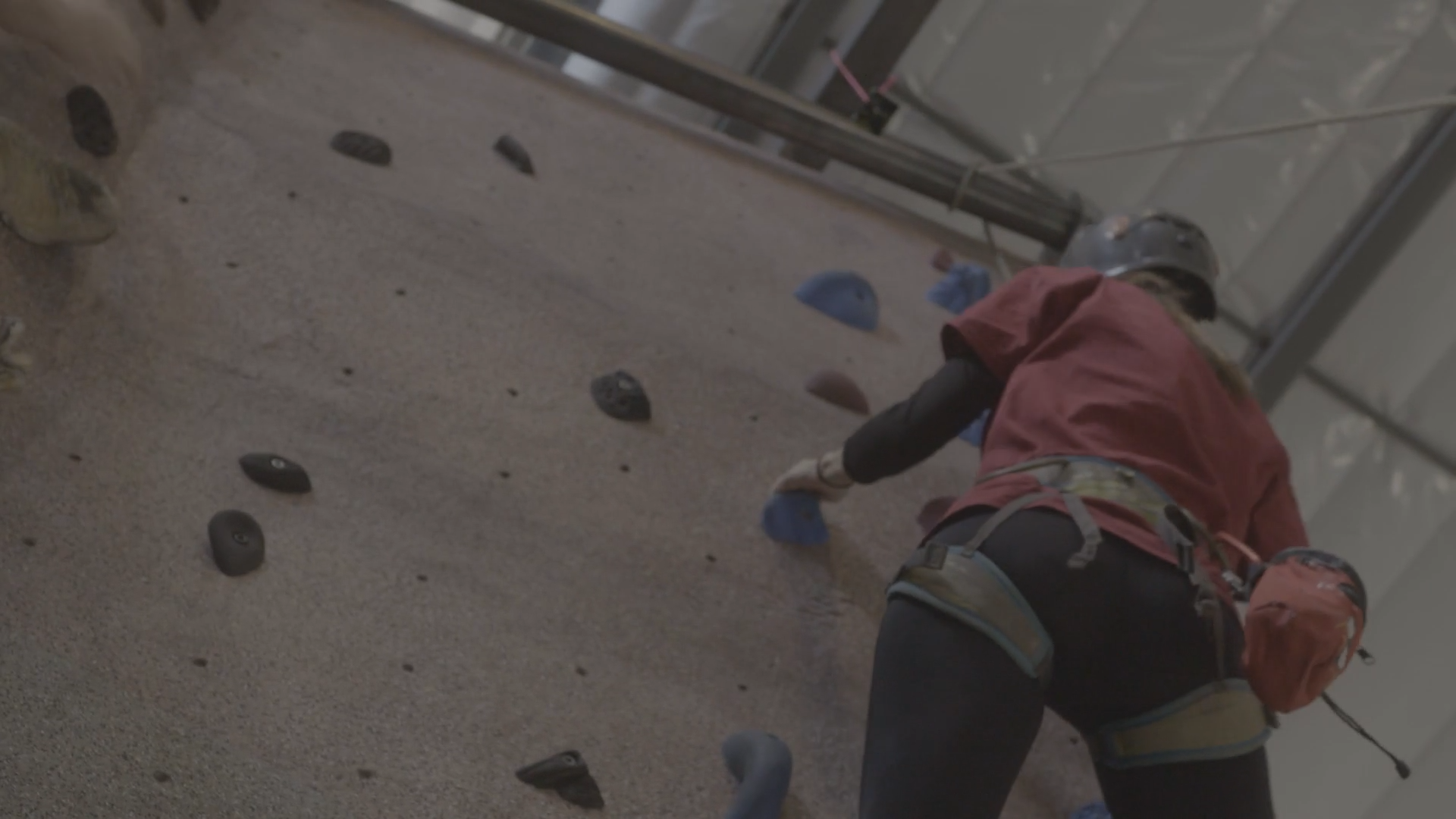 student on indoor climbing wall